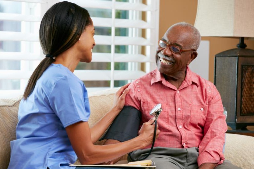 Nurse holding happy elderly patient